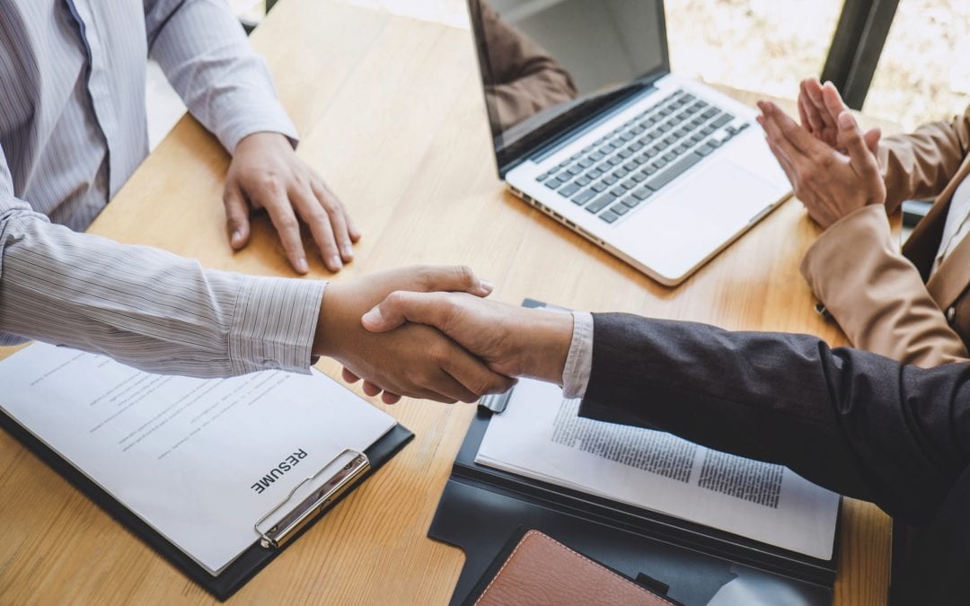 Greeting new colleagues, Handshake while job interviewing, male candidate shaking hands with Interviewer or employer after a job interview, employment and recruitment concept